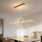 Gold bar pendant lit in a paneled room with a stone fireplace at the far end