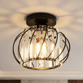Crystal cage ceiling light lit up close, throwing a starburst pattern across the ceiling
