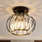 Crystal cage ceiling light lit up close, throwing a starburst pattern across the ceiling