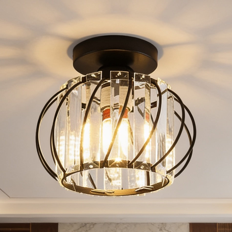 Crystal cage ceiling light lit up close, throwing a starburst pattern across the ceiling