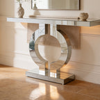 Chrome ring console with a mirrored top set against a paneled wall under a mirror