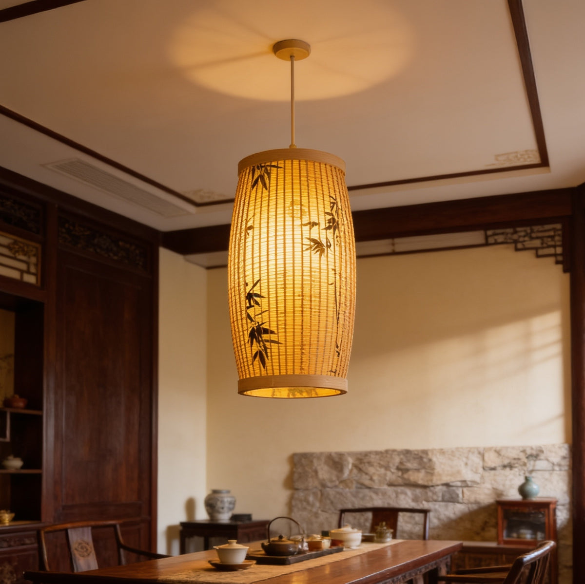 Bamboo slat lantern lit above a long wooden counter set with tea bowls