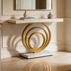 Angled view of the gold ring base and marble top with a vase and books above