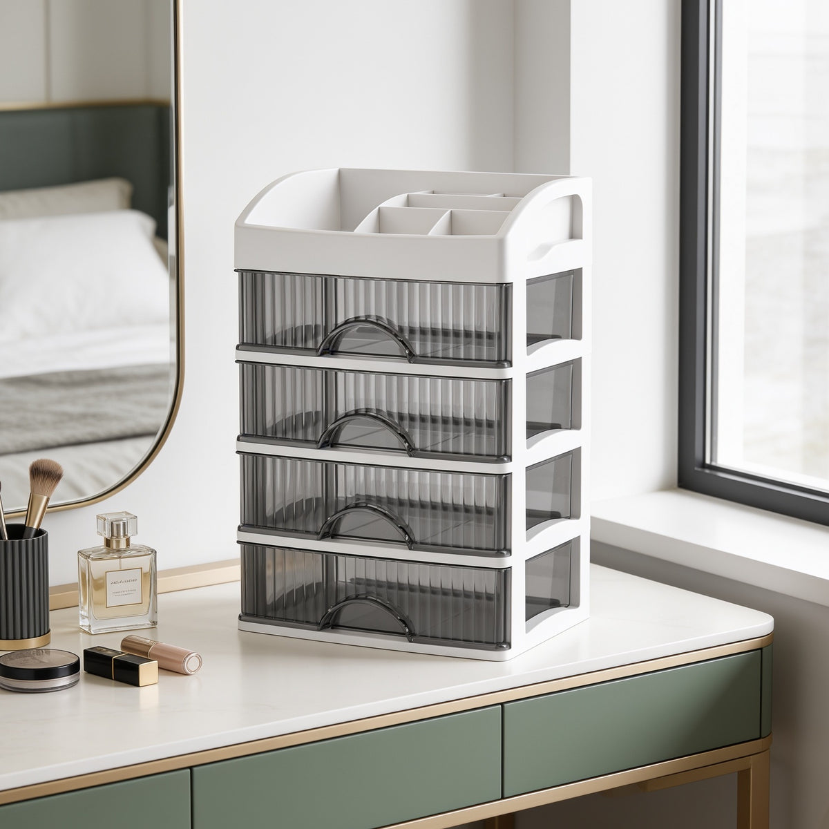Drawer organizer on a countertop by a bright window above sage green cabinets