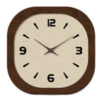 Straight on view of the cream clock face inside its rounded dark wood frame