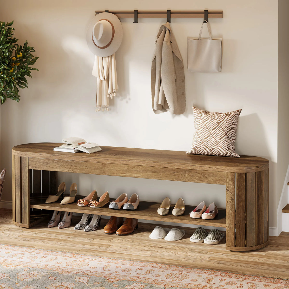 Bench under hanging coats with many pairs of shoes lined up on the shelf