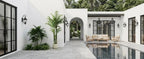 Palm plants set around a white courtyard with a pool and outdoor seating