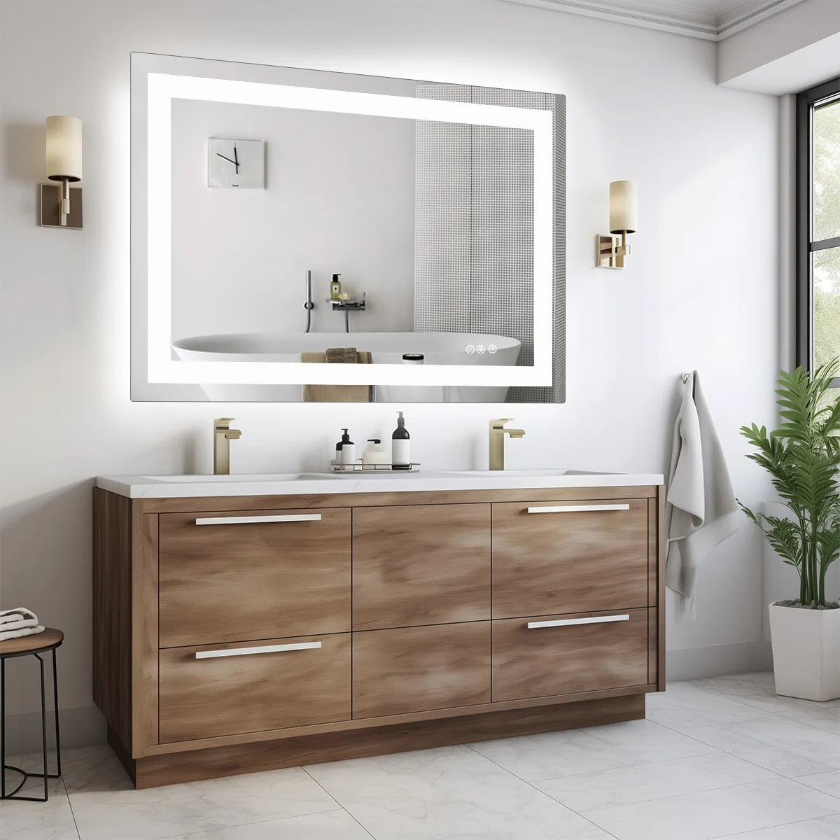 Lit mirror and warm sconces reflected above a wood vanity beside a potted plant