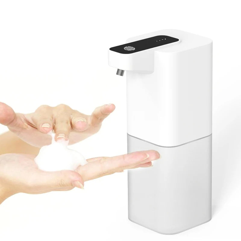 Foam pumped into two cupped hands under the touchless dispenser