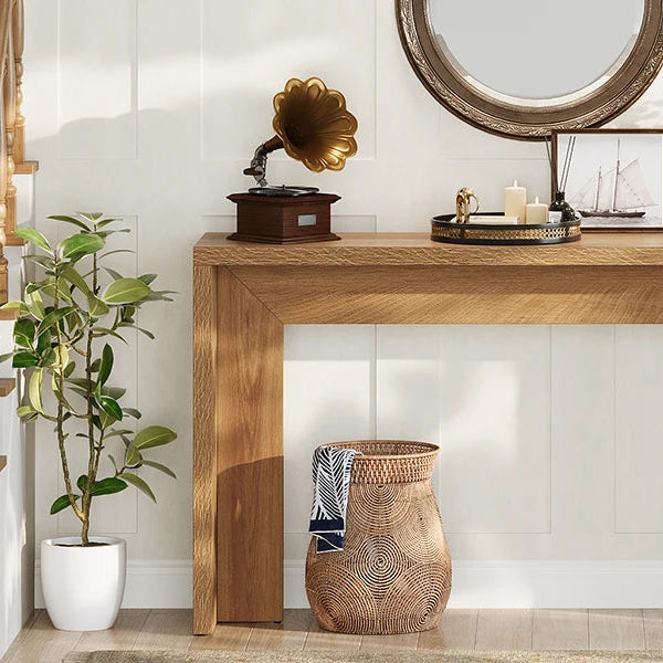 Console below a round mirror with a gramophone, tray and woven basket alongside