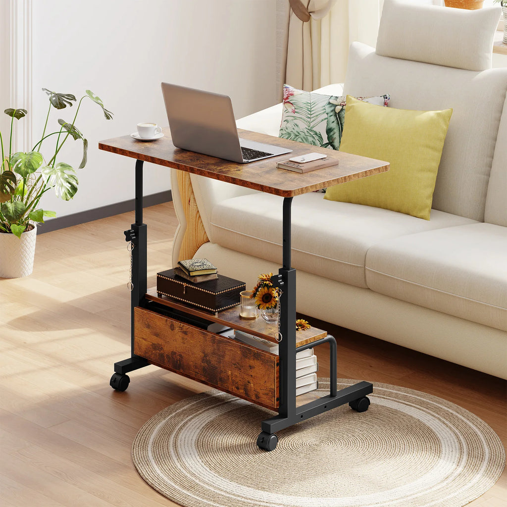 Brown rolling desk pulled over a sofa with a laptop on the raised top