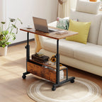 Brown rolling desk pulled over a sofa with a laptop on the raised top