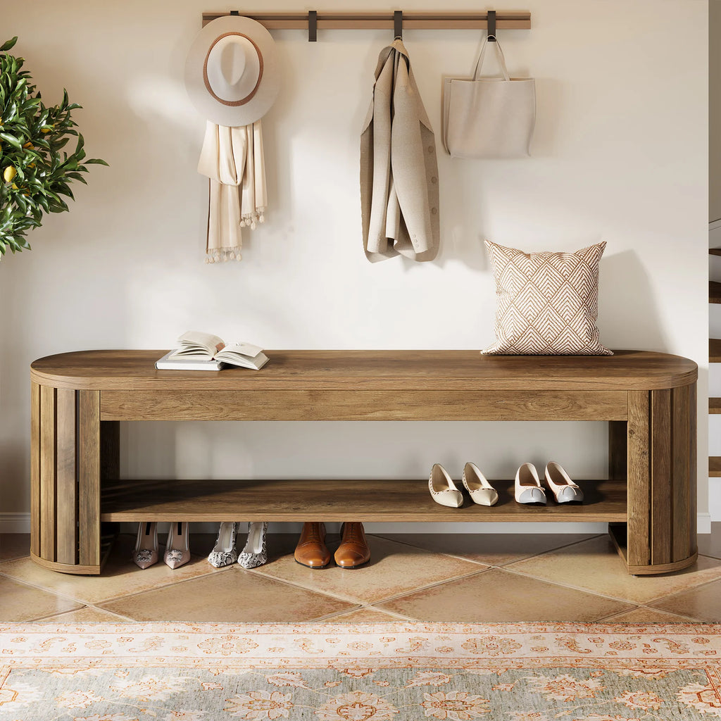 Bench below a coat rail with hats and coats above several pairs of shoes