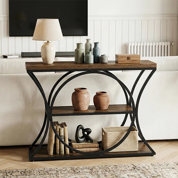 Console against white paneling below a wall screen with vases and a lamp