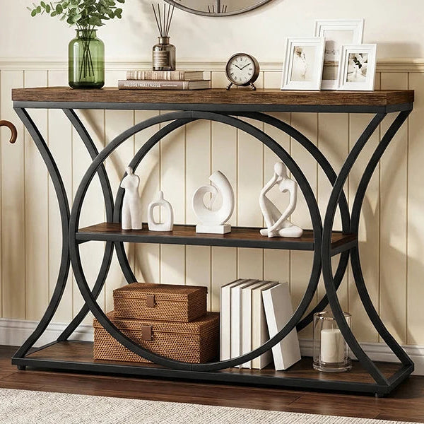 Console under a round mirror with decor on top and baskets on the shelves