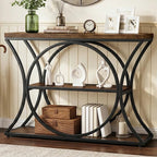 Console under a round mirror with decor on top and baskets on the shelves