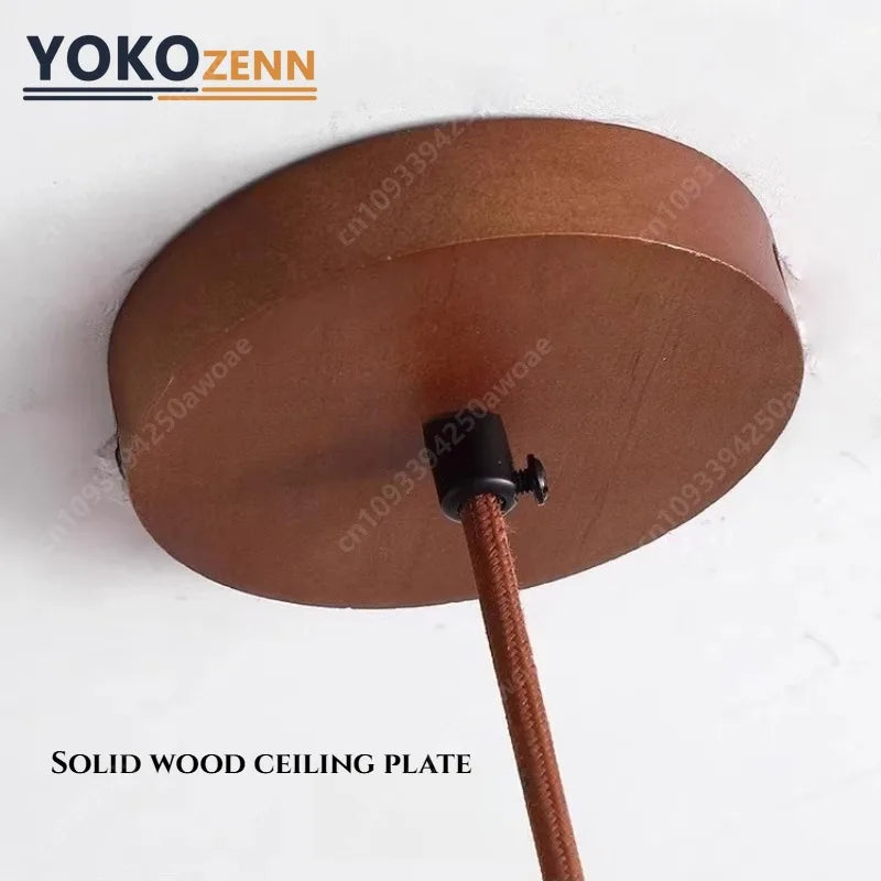 Close view of the round wood ceiling canopy and its cord