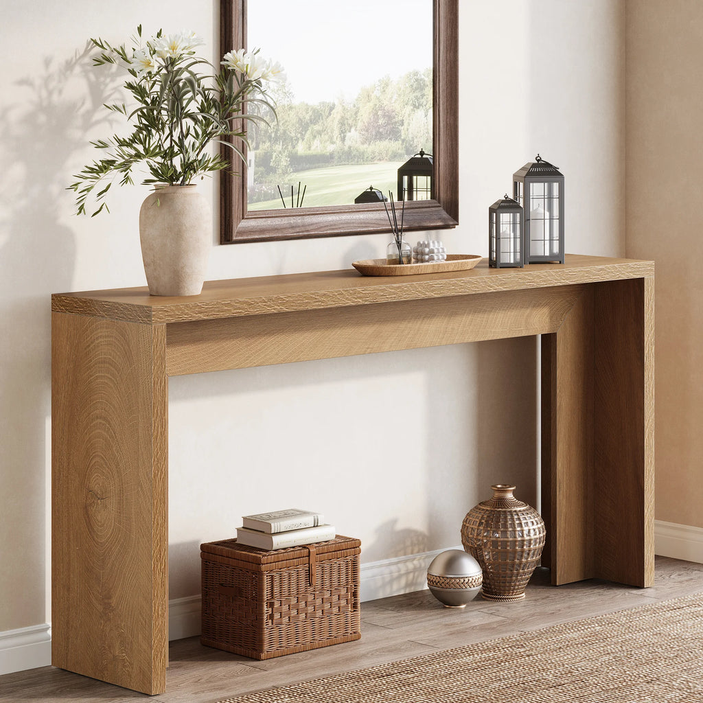 Light oak waterfall console against a wall with a plant, lanterns and a basket