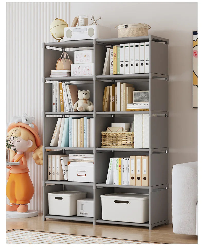 Gray and white shelf units against a wall with books, toys and storage bins