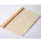 Plain bamboo rolling mat partly rolled up on a white surface