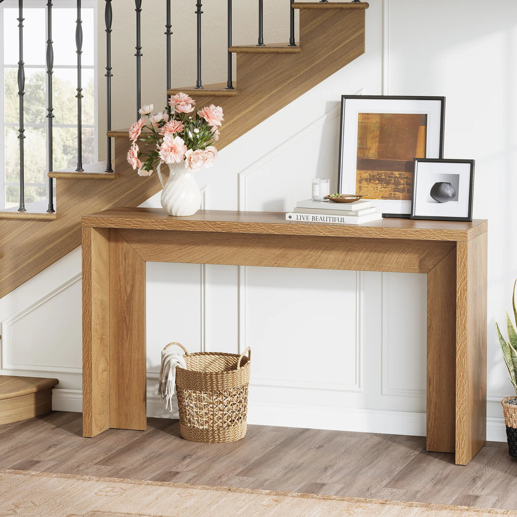 Console under a staircase with flowers and a framed print on its top