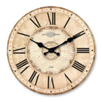 Close front view of an aged cream clock dial with black roman numerals and hands