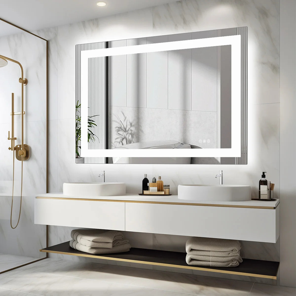 Backlit mirror reflecting daylight above a long white vanity with folded towels below