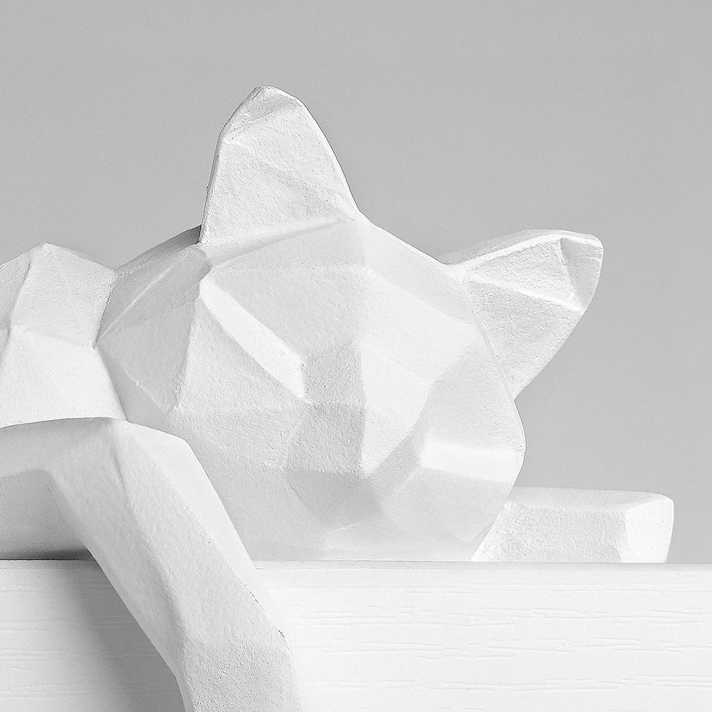 Close view of the faceted head and pointed ears on the white cat figure