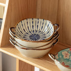 Stack of striped and floral noodle bowls resting on a wooden shelf