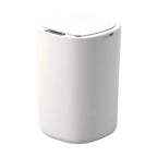 Studio view of the white sensor trash can with its rounded lid closed