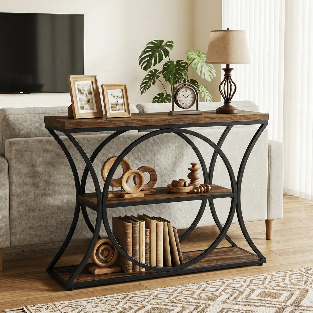 Rustic console on a curved black frame holding framed photos and a small plant