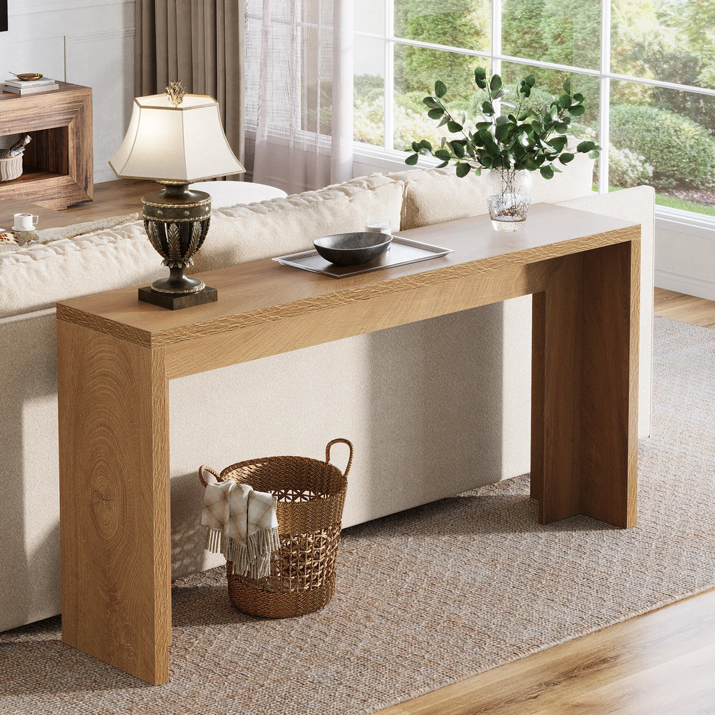 Console set behind a cream sofa with a woven basket tucked underneath