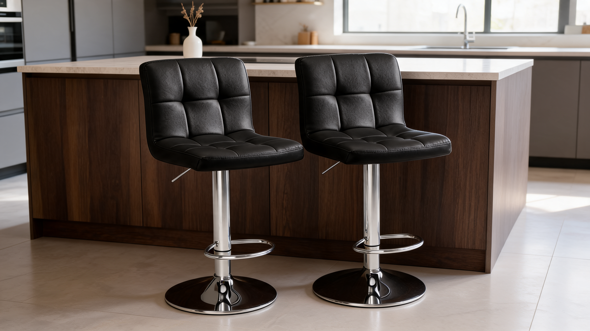 Two black bar stools at a wood island beside a window with a plant on the counter