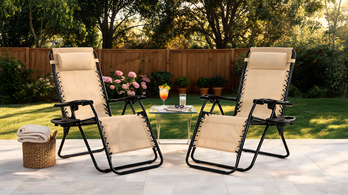 Matching pair of zero gravity recliner chairs set up side by side on a patio