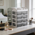 Frosted drawer tower on a marble vanity with perfume bottles and a brush cup nearby