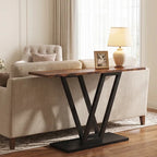 Narrow V base console standing behind a cream sofa with a lamp and framed photo