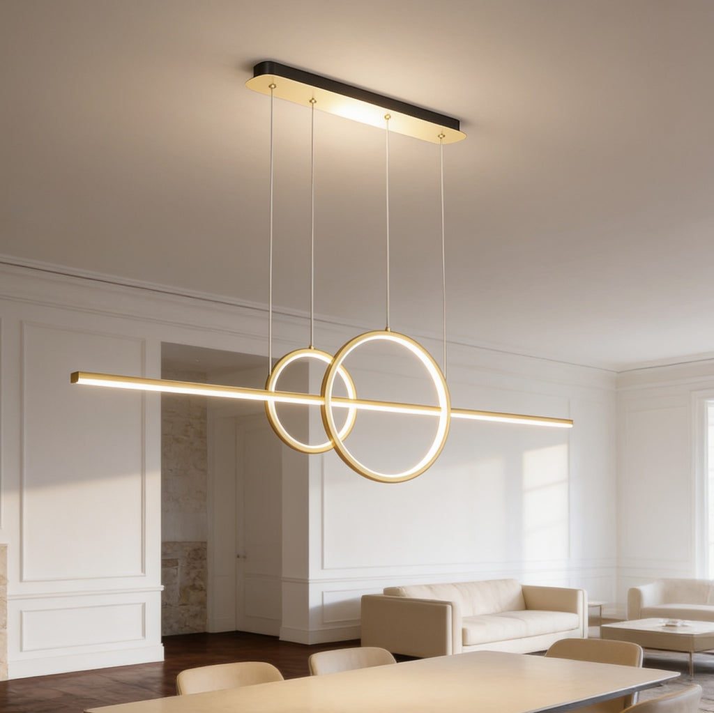 Gold ring and bar LED pendant lit above an open plan dining and living space