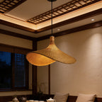Two woven bamboo shades lit above a seating area under a coffered wood ceiling