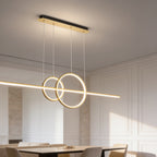 Linear LED pendant with two gold rings hanging over a dining table and chairs