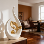 Close view of a white and gold flame shaped statue on wood with a living room behind