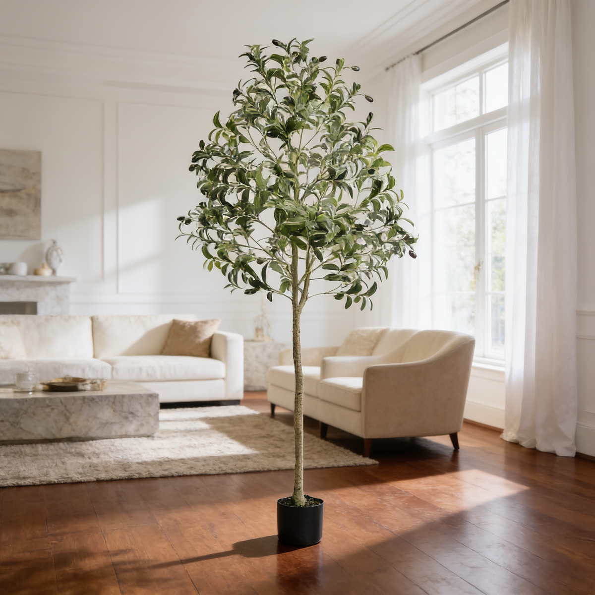 Artificial tree in a black pot by a window with white sofas on a wood floor