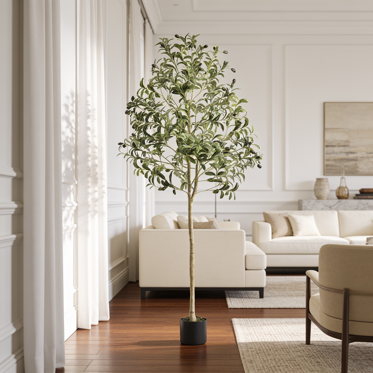 Faux olive tree in a black nursery pot in a paneled room with a cream sofa