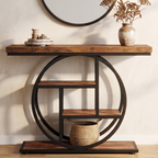 Wood console on a black ring frame in an entryway below a round mirror