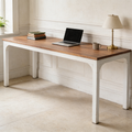 Long wood top workstation on white legs with a laptop and shaded lamp