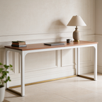 Wood top desk with white legs viewed from the left with a lamp and books