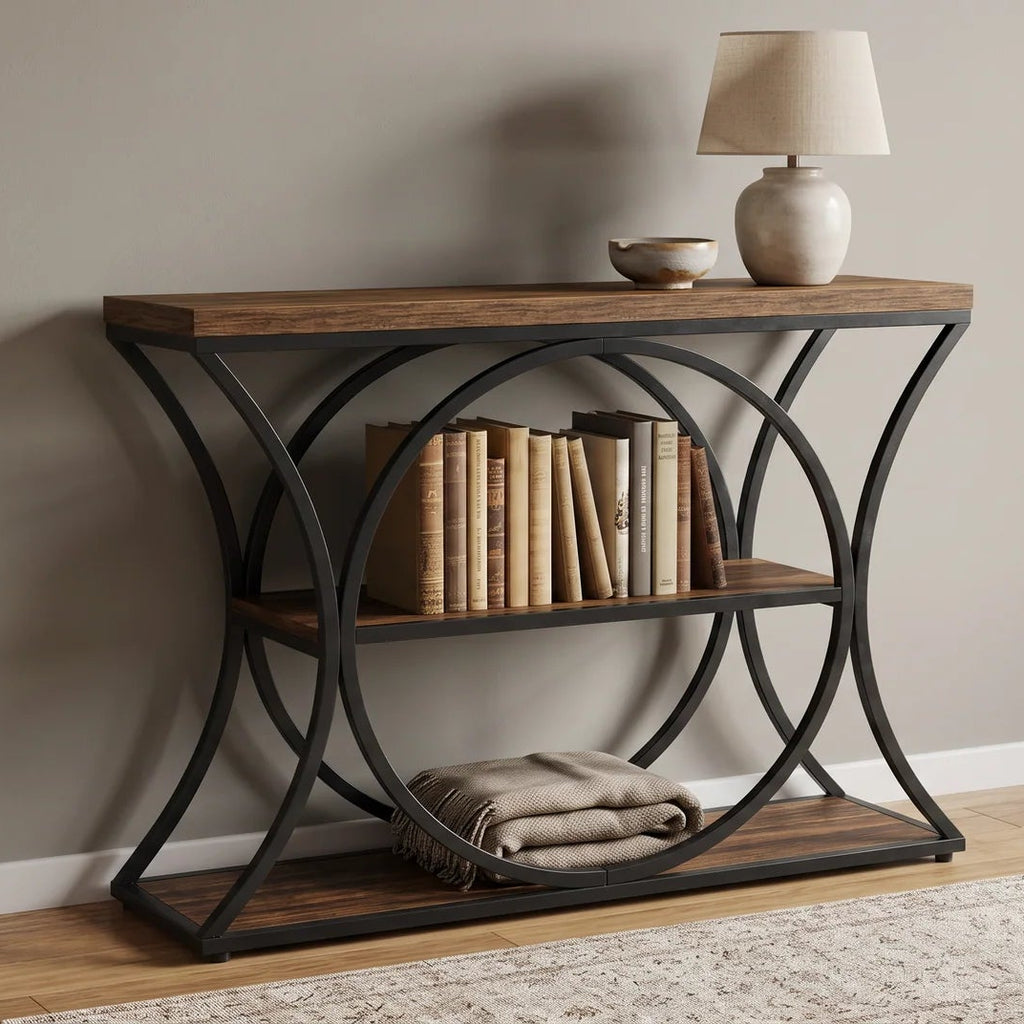 Console beside a sofa with books and a folded blanket on the lower shelves