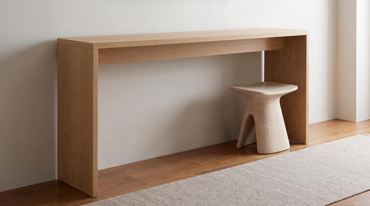 Open space beneath the waterfall console table with a single stool