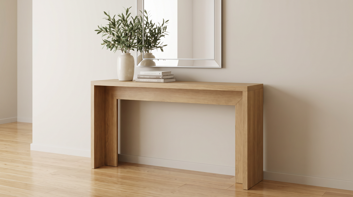 Waterfall console table in an entryway below a framed mirror