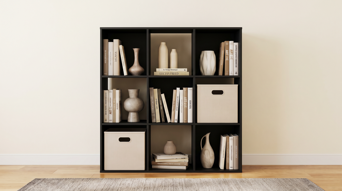 Black nine cube storage bookcase styled with books in a living room