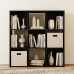 Matte black cube shelf styled with books, vases and cream fabric bins